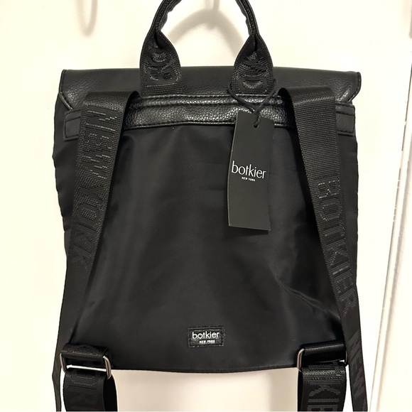 botkier trigger leather backpack - black NWT New York Second Bite Details 100% polyester with 100% polyurethane trim Gunmetal hardware Magnetic snap flap closure Adjustable nylon webbed backpack straps Interior zip pocket Lining 100% polyester Measurements Height 9 in (23 cm)Length 9.5 in (24 cm)Depth 4 in (10 cm)Strap Length 33 in (84 cm)Strap Width 1.5 in (4 cm) Botkier New York Trigger Mini